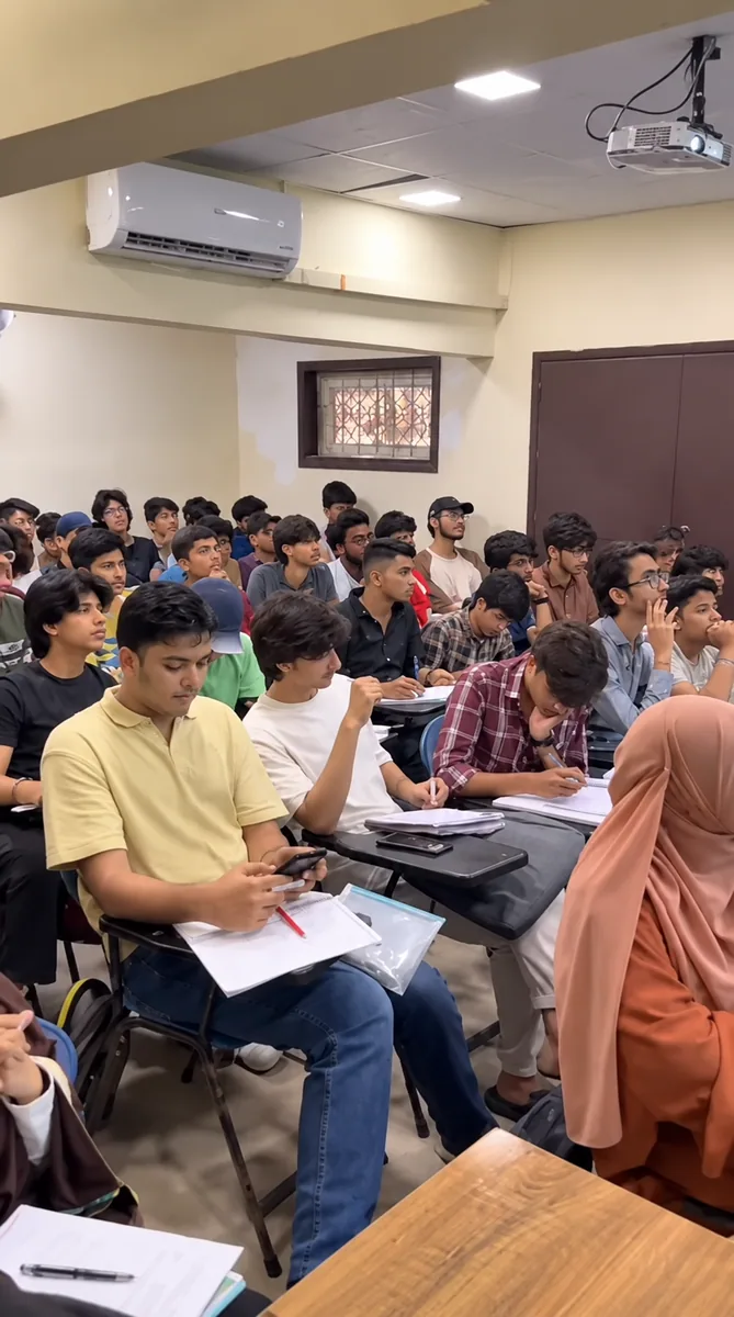 Students listening and writing notes in an air-conditioned classroom